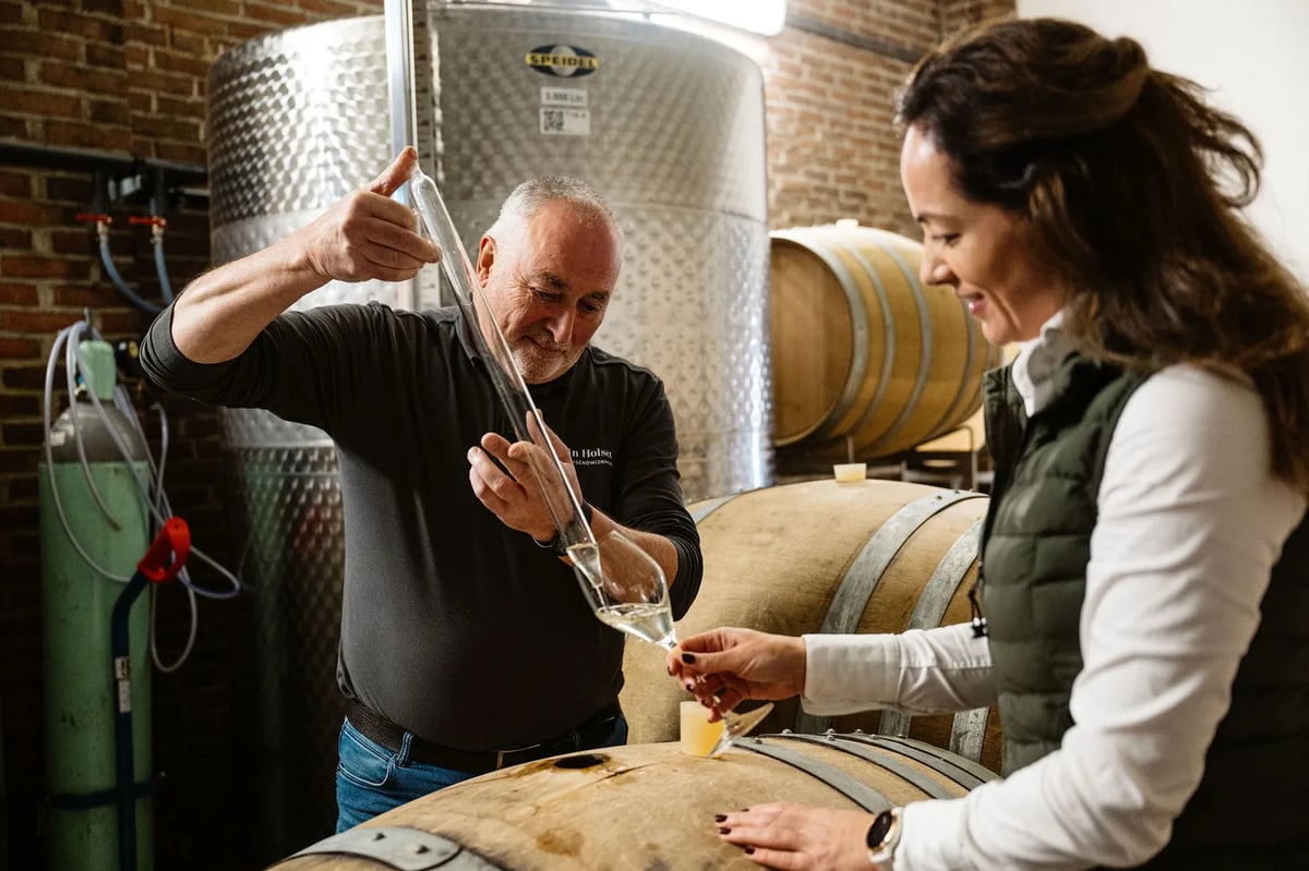 Winemaker and director Kirsten Abels tasting a cask sample of sparkling wine in the Domein Holset cellar