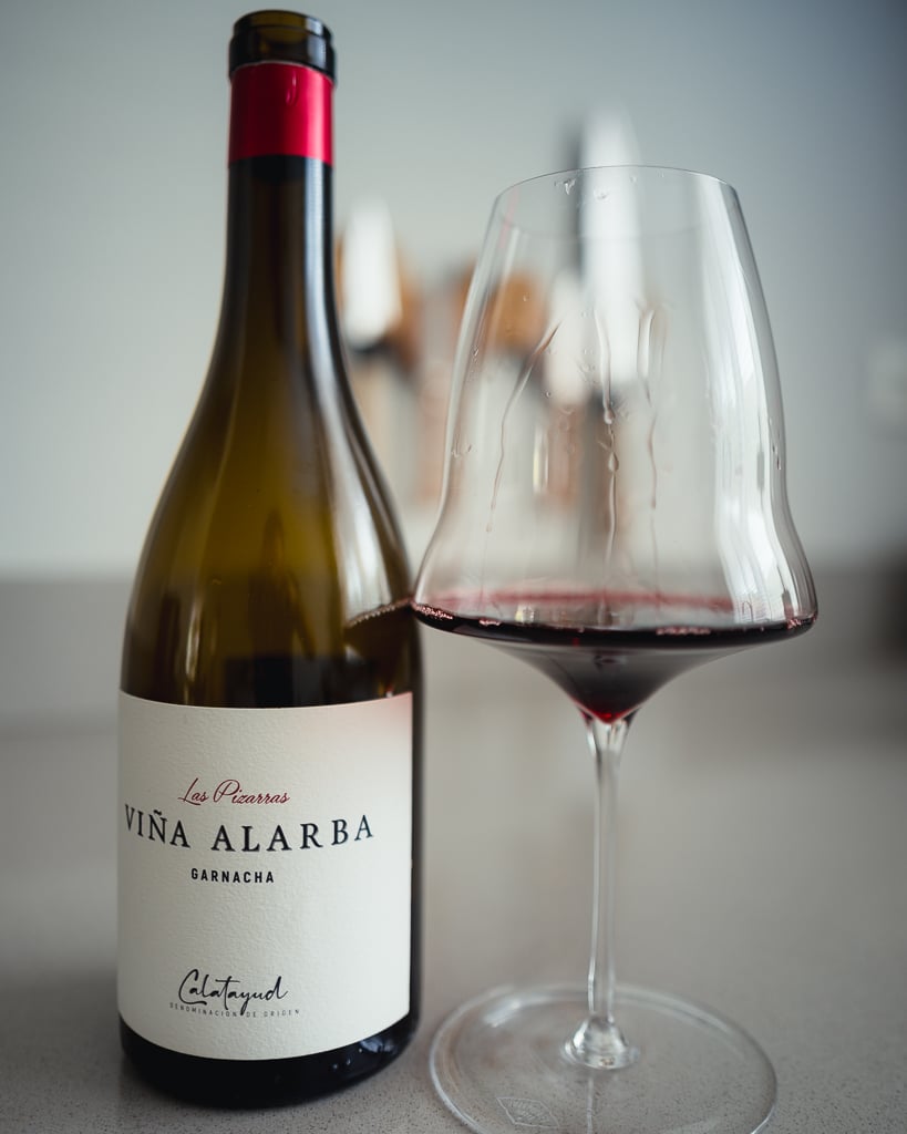 Viña Alarba Garnacha bottle from Calatayud beside a glass of red wine