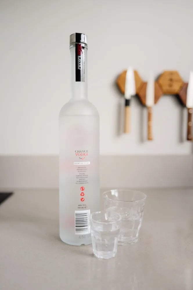 Back of the Chance Vodka bottle showing production details from Poland, next to two glasses