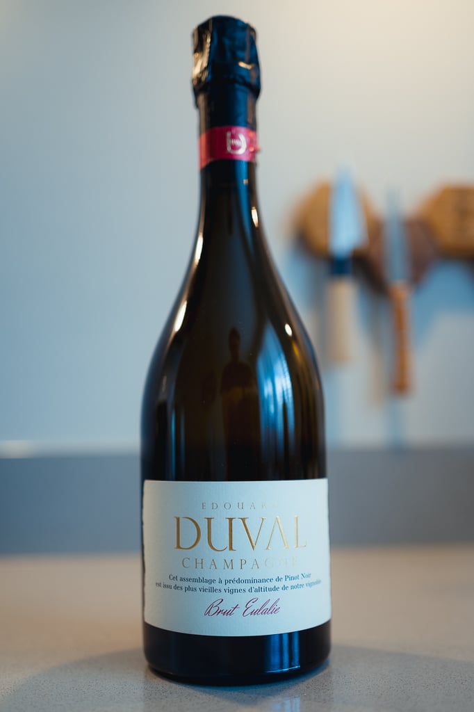 Edouard Duval Brut Eulalie bottle with red foil collar standing on a counter