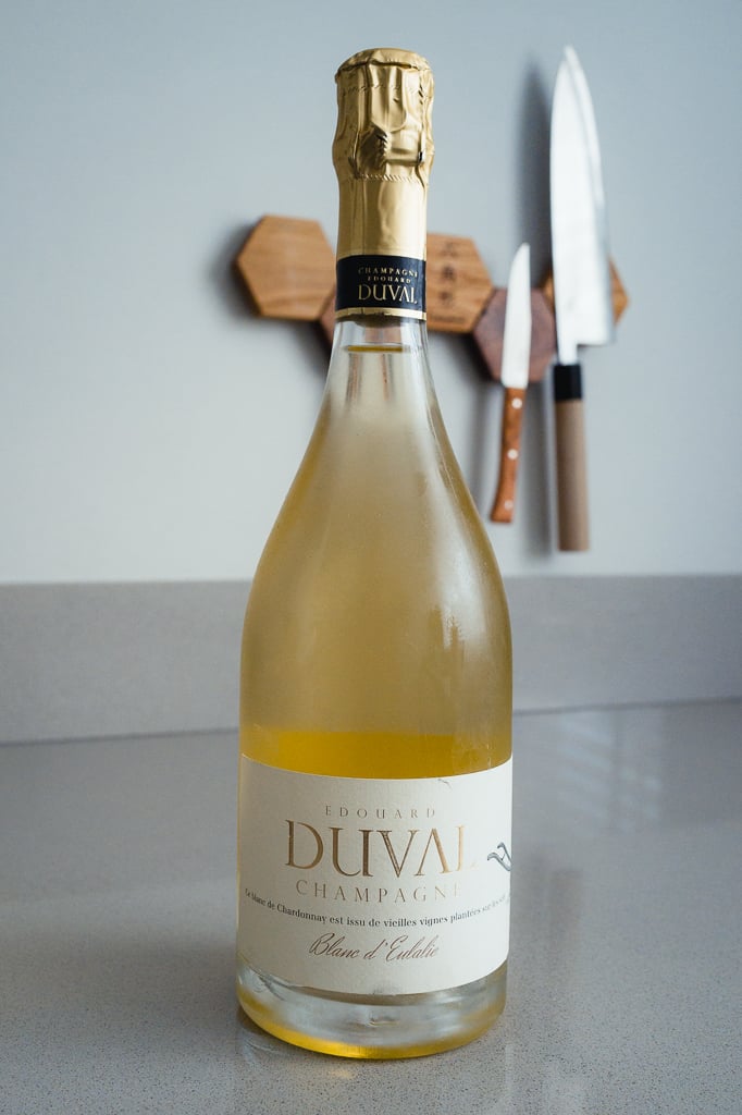 Edouard Duval Blanc d'Eulalie bottle with gold foil standing on a counter against knives on the wall
