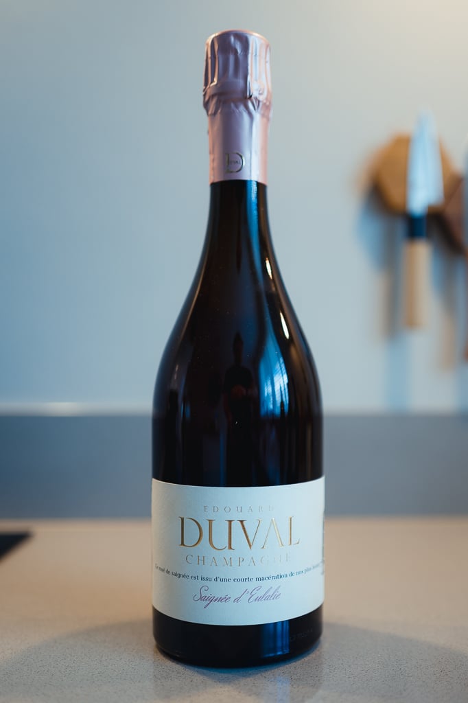 Edouard Duval Saignée d'Eulalie bottle with pink foil collar standing on a counter