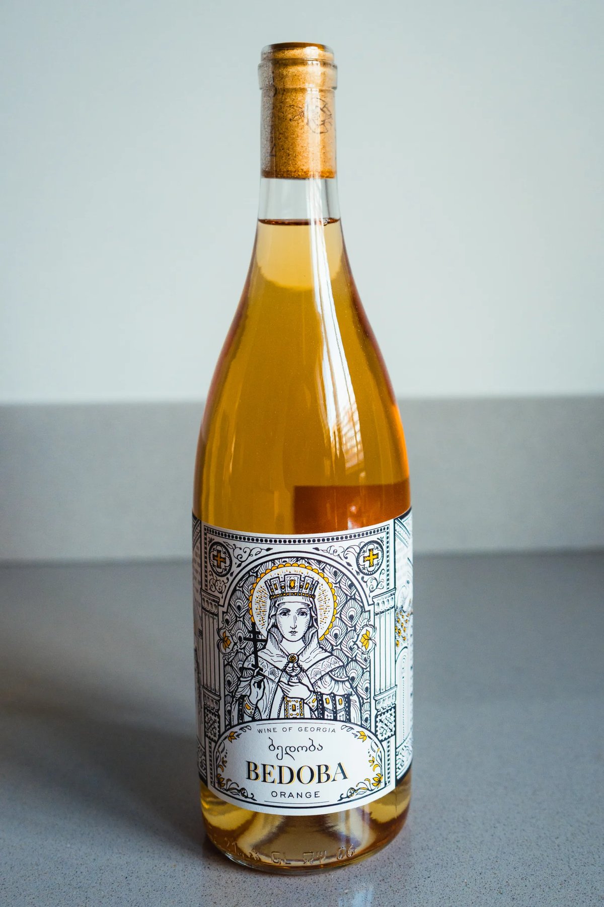 Bedoba orange wine bottle from Georgia with an illustrated saint on the label