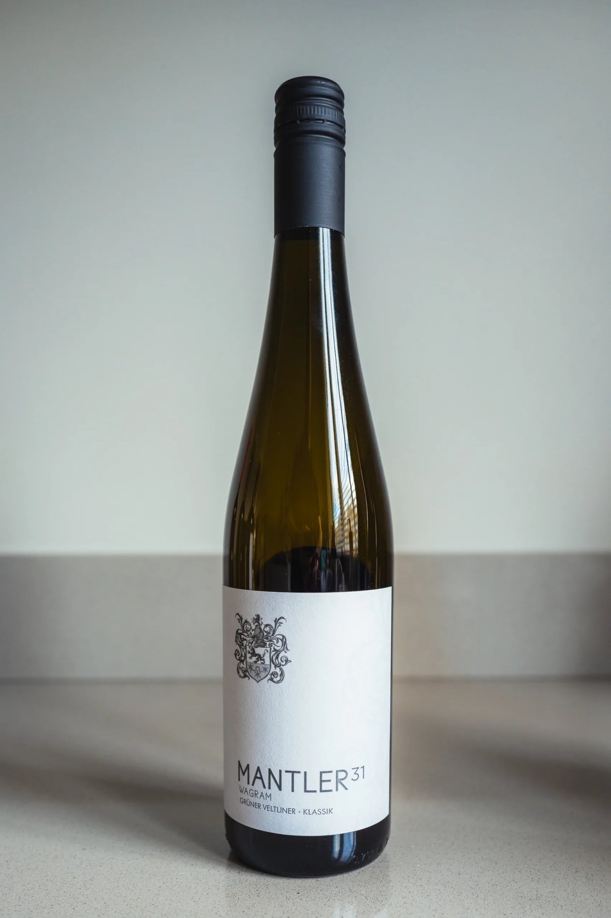 Mantler 31 Grüner Veltliner Klassik bottle with dark cap standing on a counter
