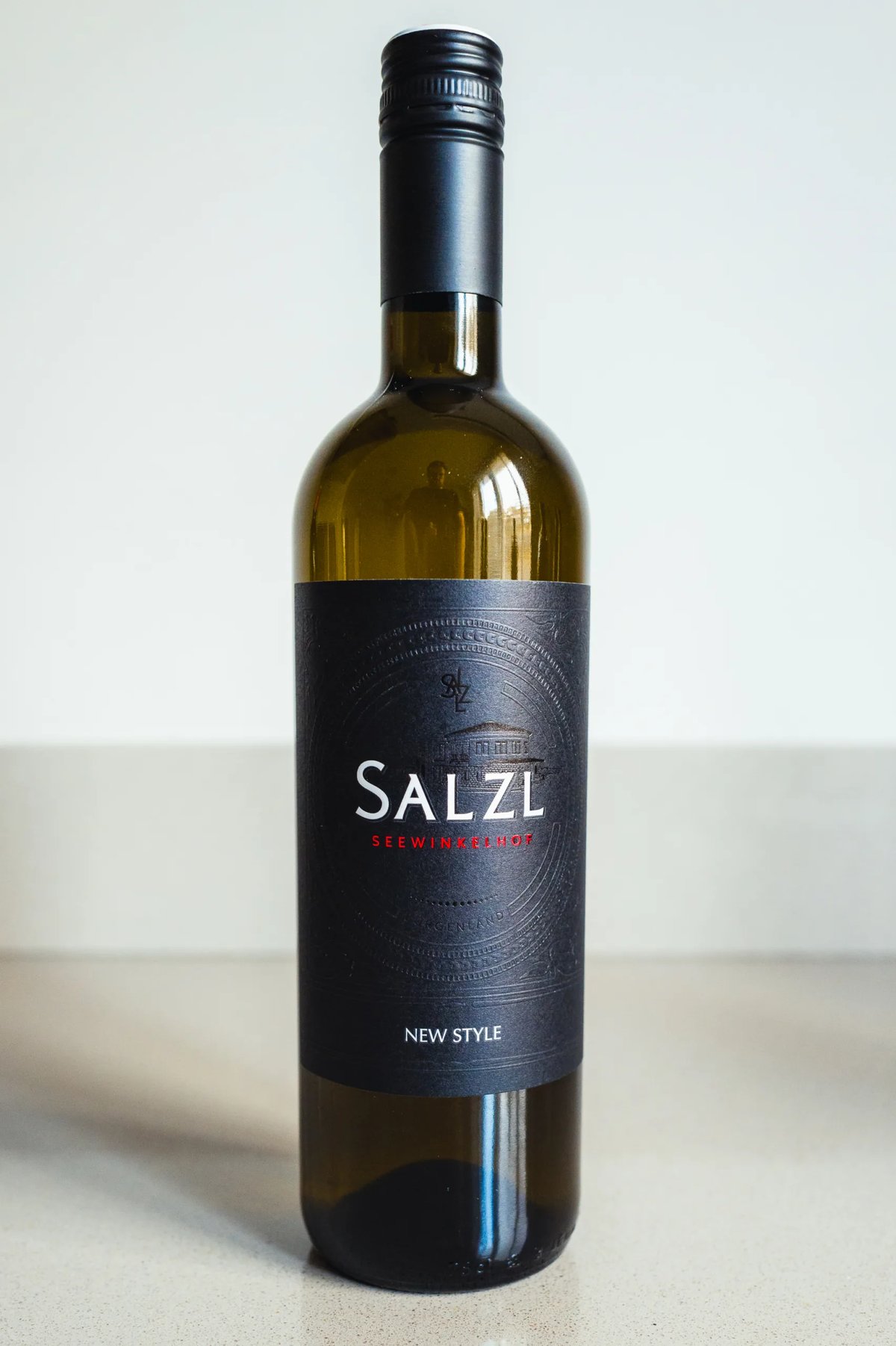 Salzl New Style bottle with a black label standing on a counter