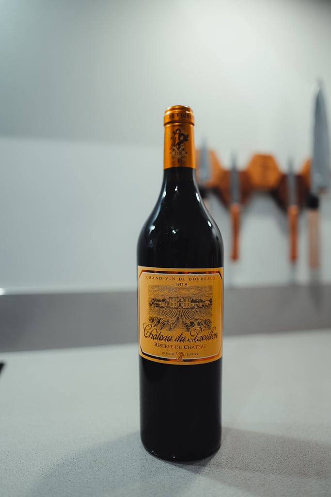 Standing bottle of Château du Pavillon 2018 Réserve red wine on a kitchen counter