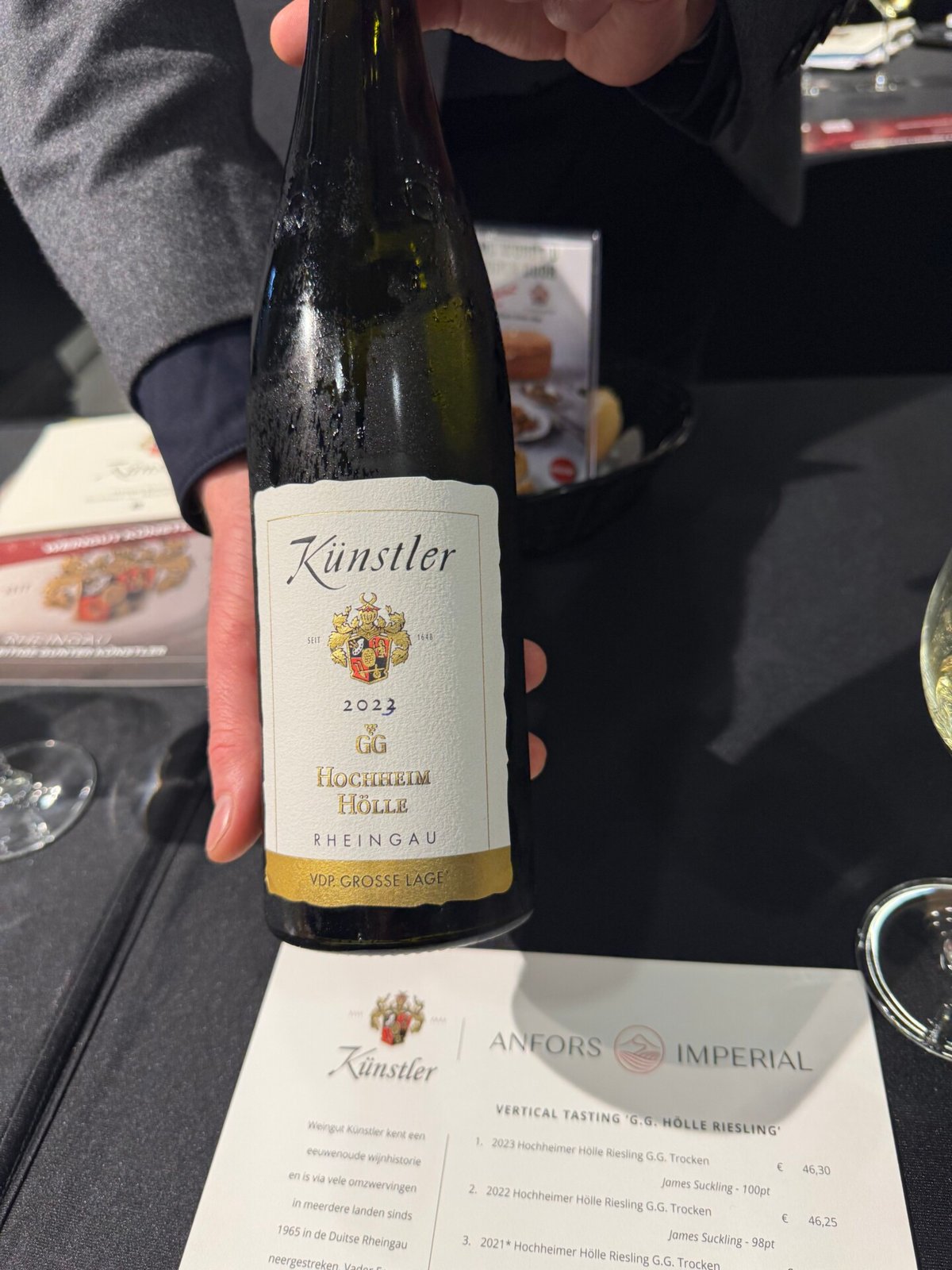 Kunstler 2023 GG Holle Riesling bottle held above the Anfors Imperial vertical tasting sheet