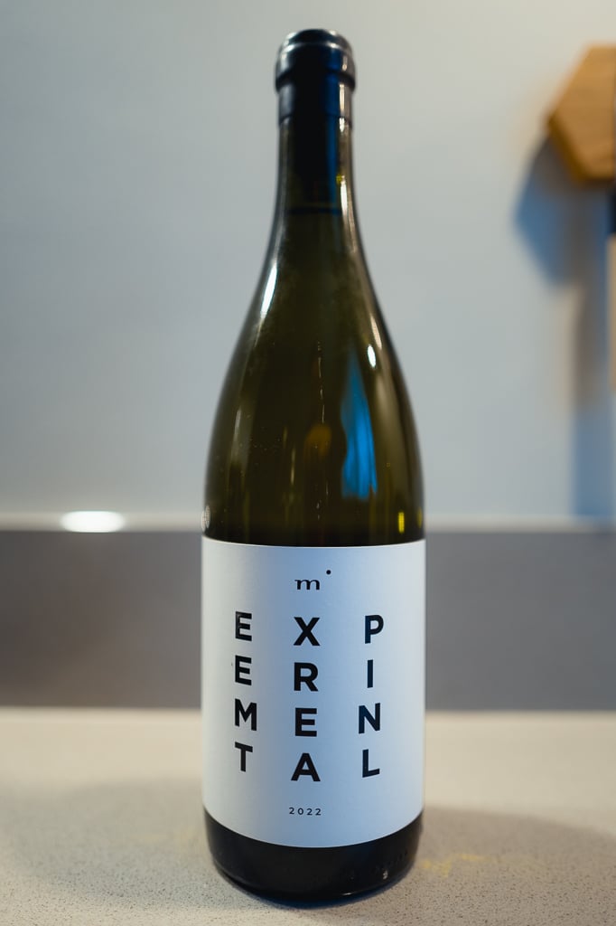 Minimalist Wines Experimental white bottle standing alone on a counter