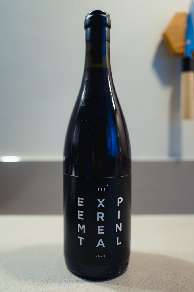 Minimalist Wines Experimental dark bottle standing alone on a counter