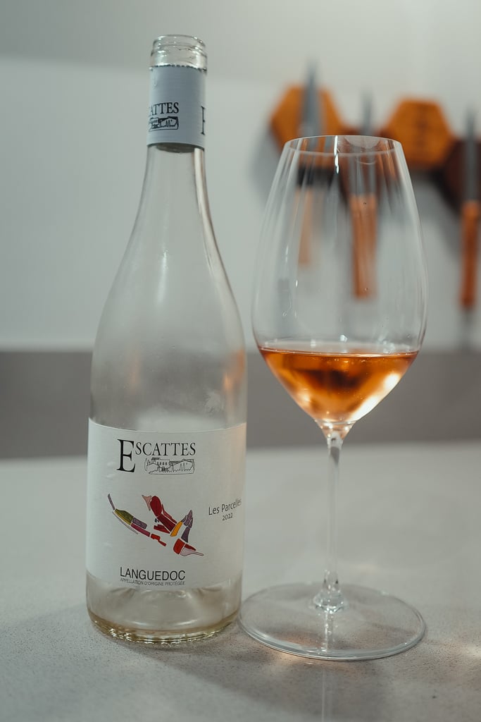 Clear Escattes Languedoc bottle beside a glass of pale rosé wine
