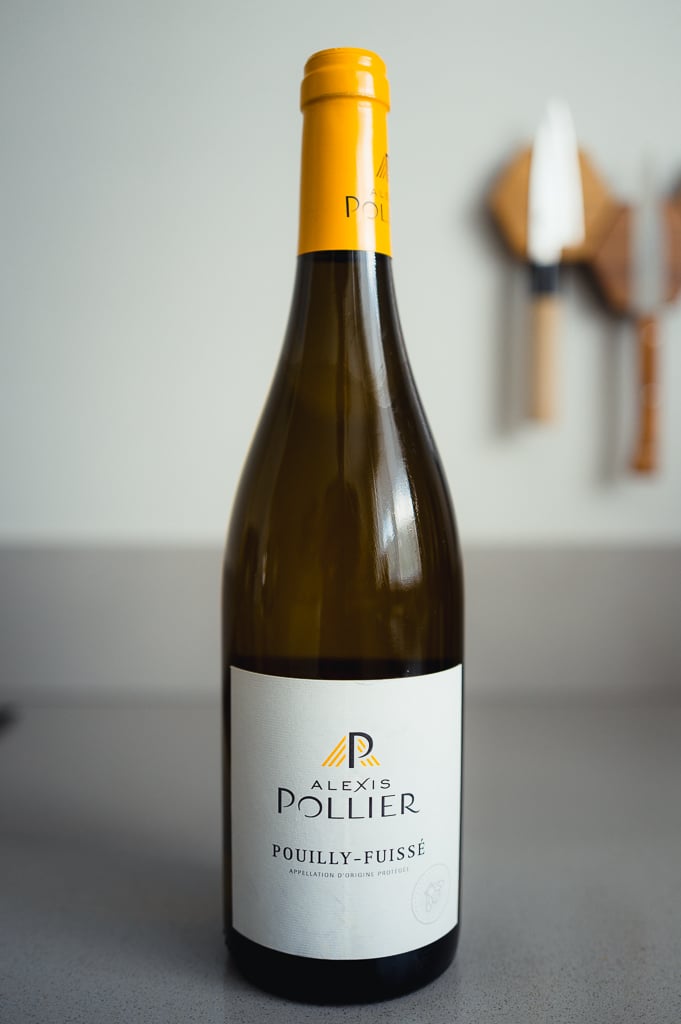 Bottle of Alexis Pollier Pouilly-Fuissé with a white label and yellow R logo