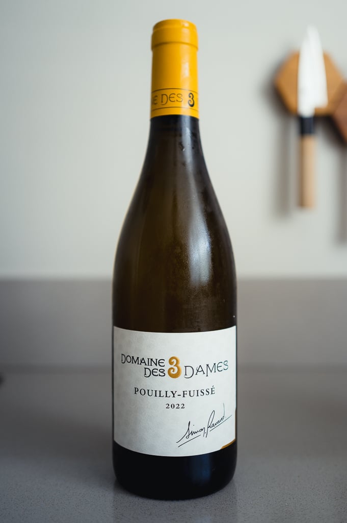 Bottle of Domaine des 3 Dames Pouilly-Fuissé 2022 with a yellow capsule