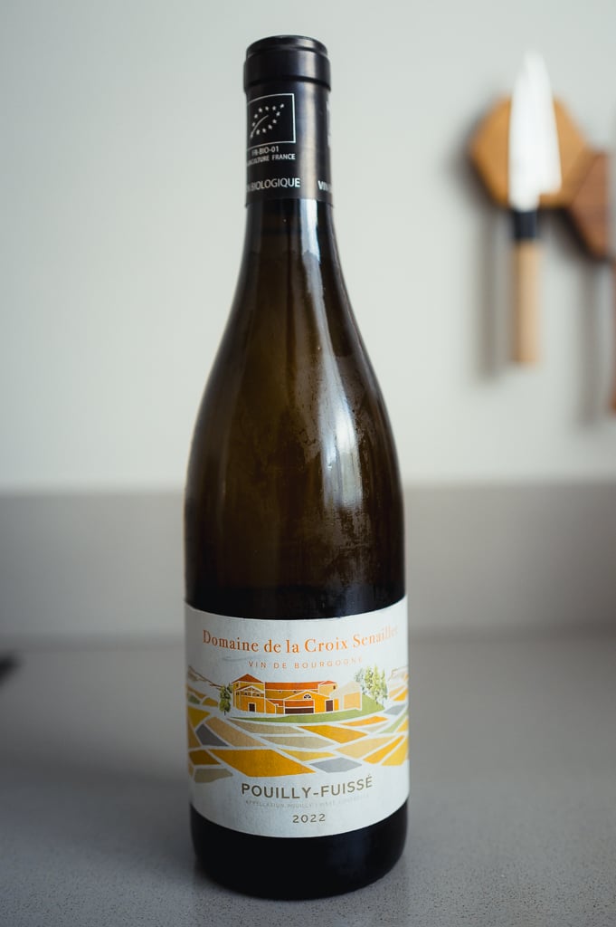 Bottle of Domaine de la Croix Senaillet Pouilly-Fuissé 2022 with an illustrated vineyard label
