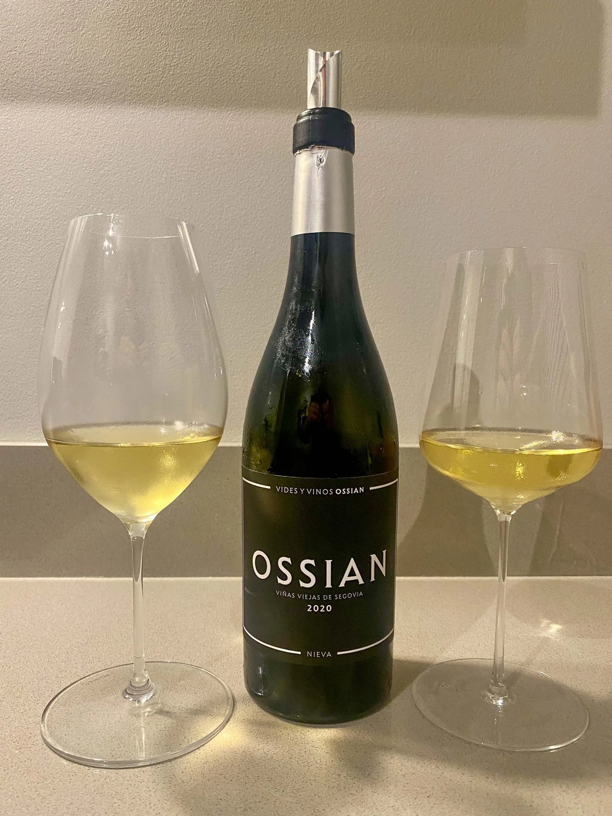Ossian 2020 white wine bottle standing between two glasses of golden white wine