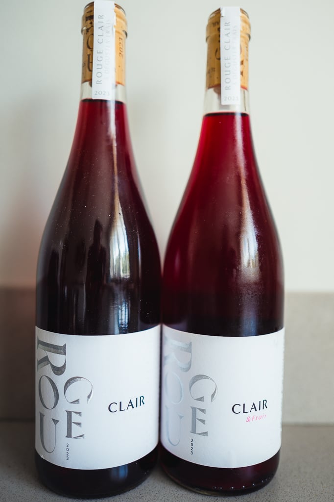 Two M. Chapoutier Rouge Clair bottles of light red wine standing side by side