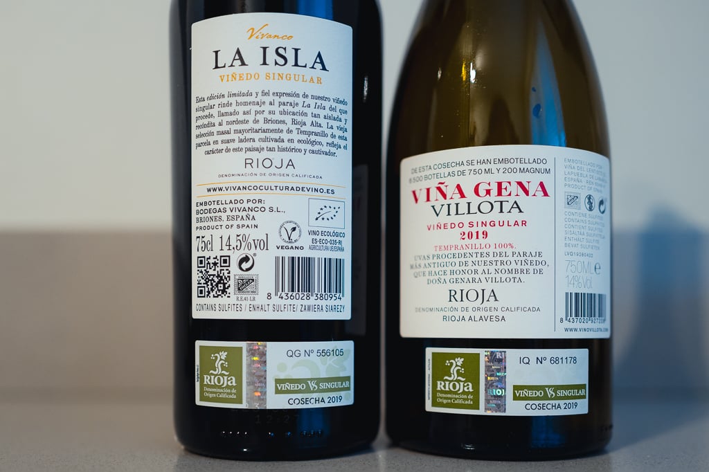 Back labels of Vivanco La Isla and Viña Gena Villota Viñedo Singular Rioja side by side