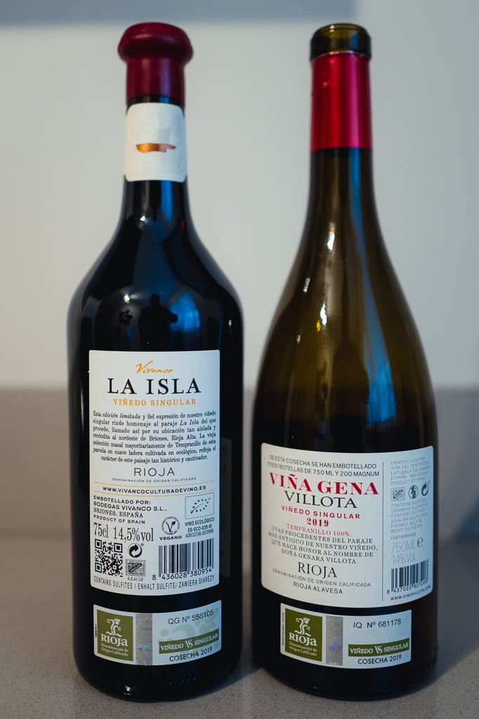 Back labels of two Viñedo Singular Riojas La Isla and Viña Gena Villota with numbered seals