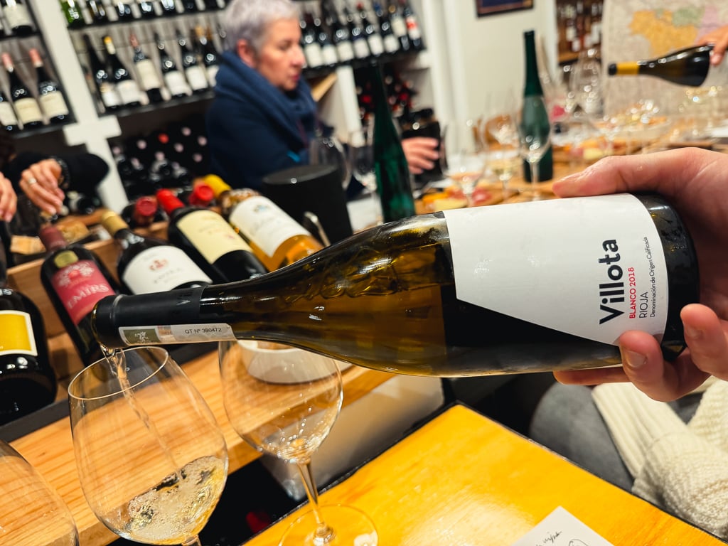 Villota Blanco being poured into a glass at the Vindict wine bar table
