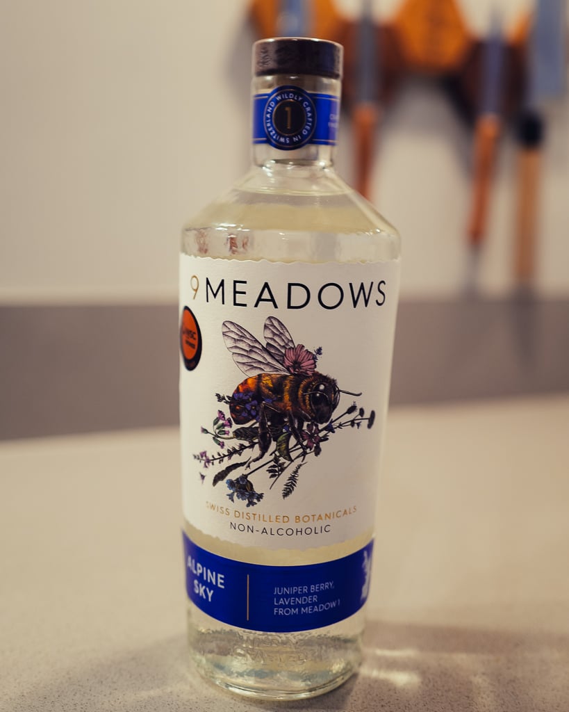 Clear Alpine Sky bottle with detailed honeybee and wildflower label illustration