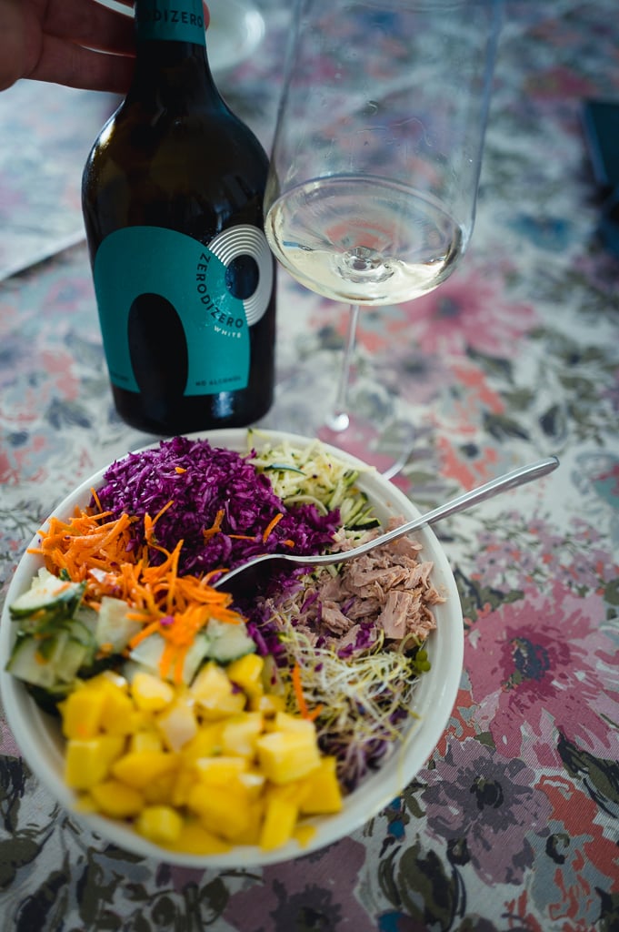 ZeroDiZero bottle and glass beside a colourful salad bowl of vegetables and tuna