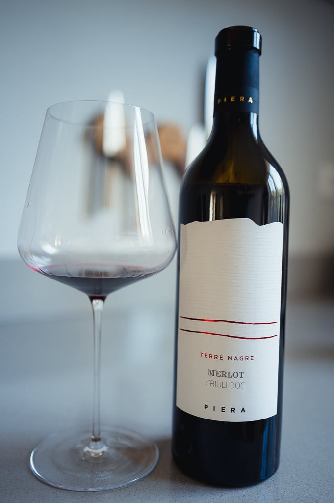 Piera Terre Magre Merlot bottle next to a glass holding a little red wine