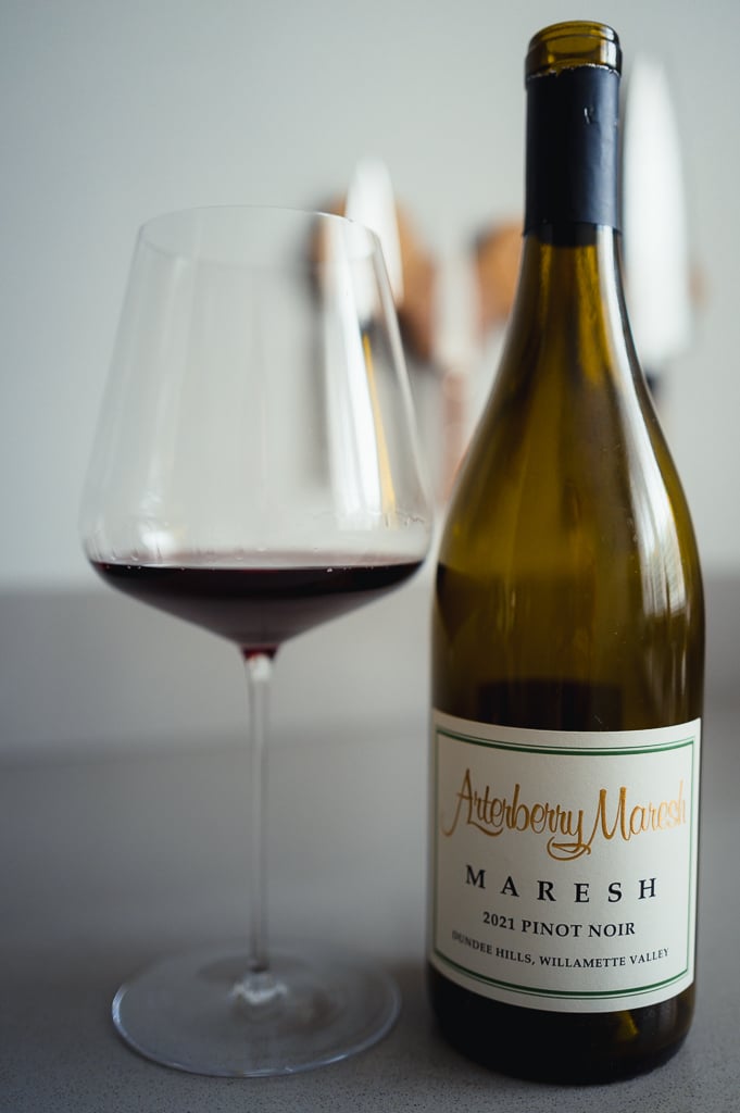 Arterberry Maresh 2021 Pinot Noir bottle beside a glass of red wine