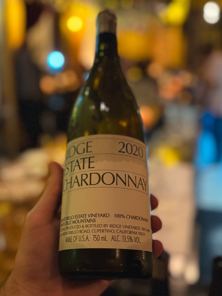 Hand holding the Ridge Estate Chardonnay 2020 bottle at the tasting