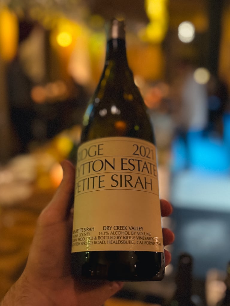 Hand holding the Ridge Lytton Estate Petite Sirah 2021 bottle at the bar