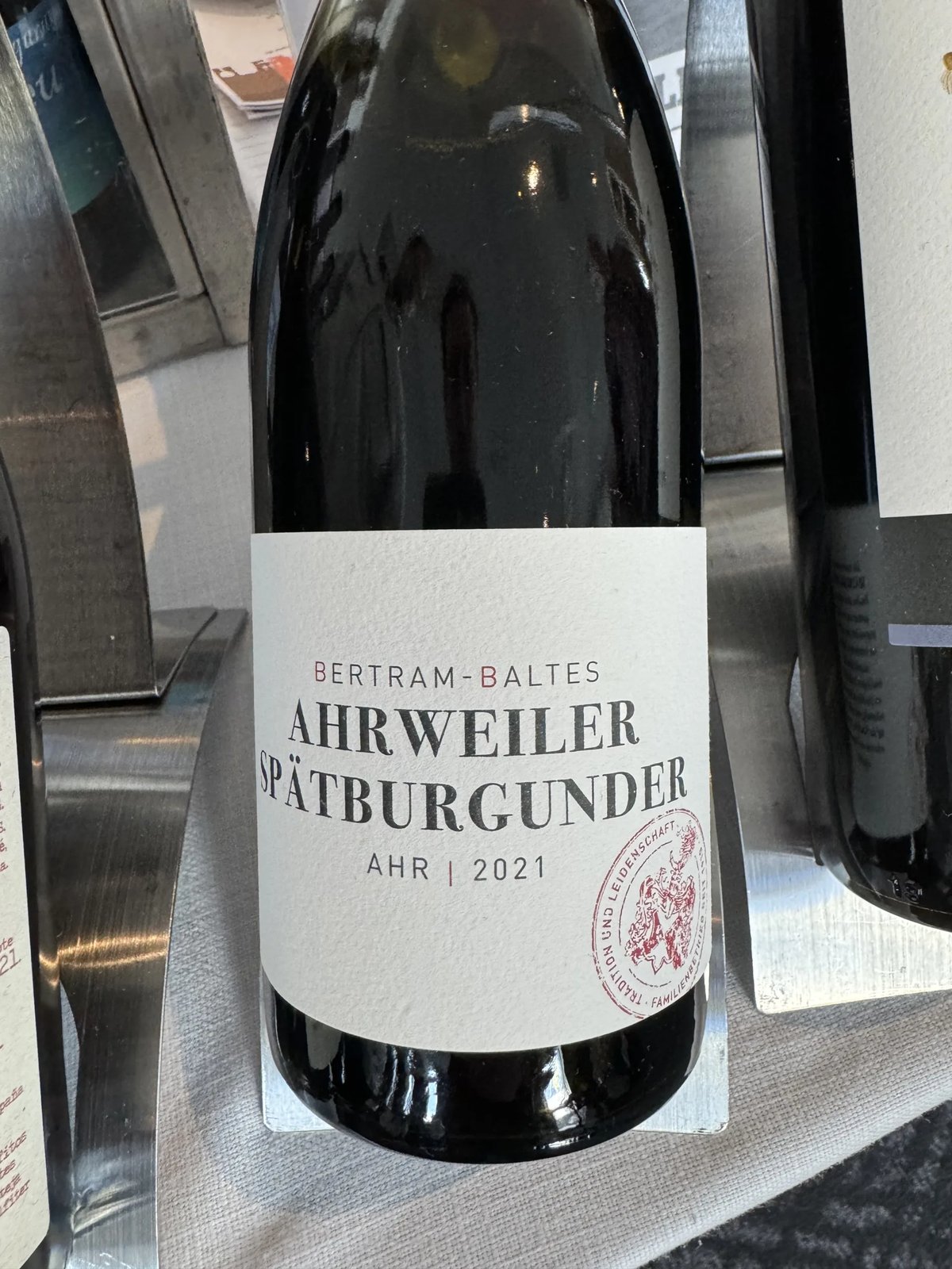Bertram-Baltes Ahrweiler Spätburgunder Ahr 2021 bottle on a metal pourer stand at the tasting
