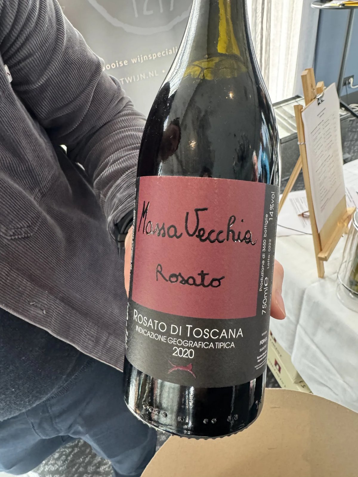 Massa Vecchia Rosato di Toscana 2020 bottle with a handwritten name on a deep-red label, held in one hand