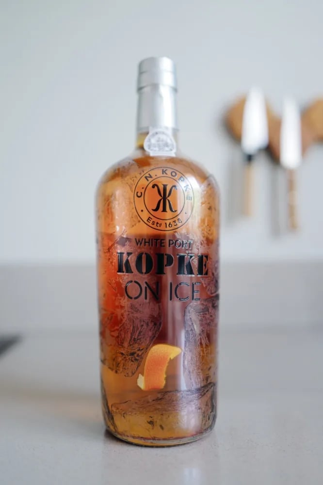 Bottle of Kopke On Ice from the front, red label and the golden colour of the white port