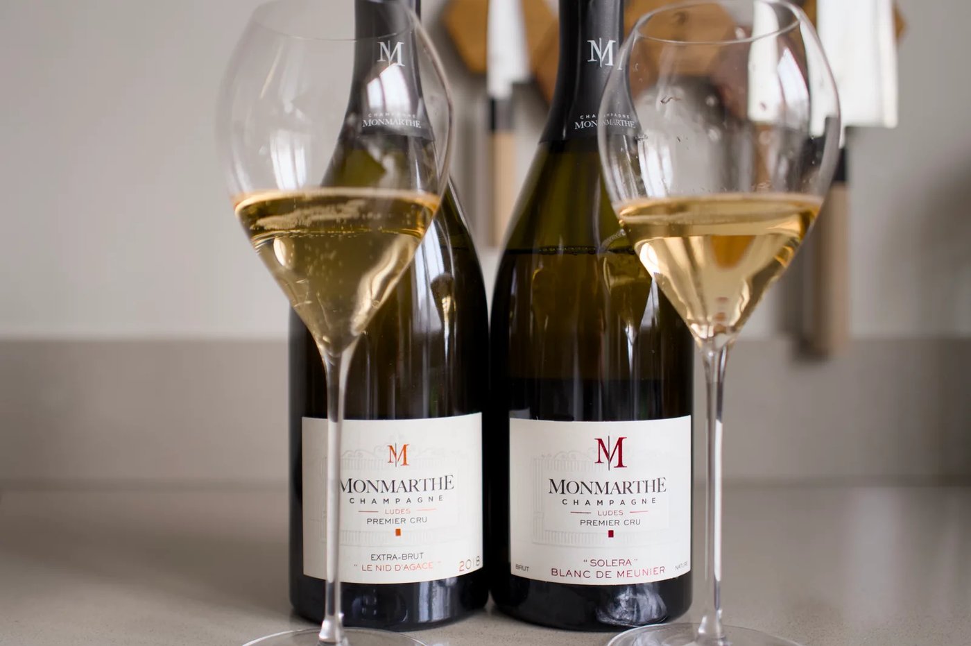 Two bottles of Champagne Monmarthe with glasses, Le Nid d'Agace and Solera Blanc de Meunier