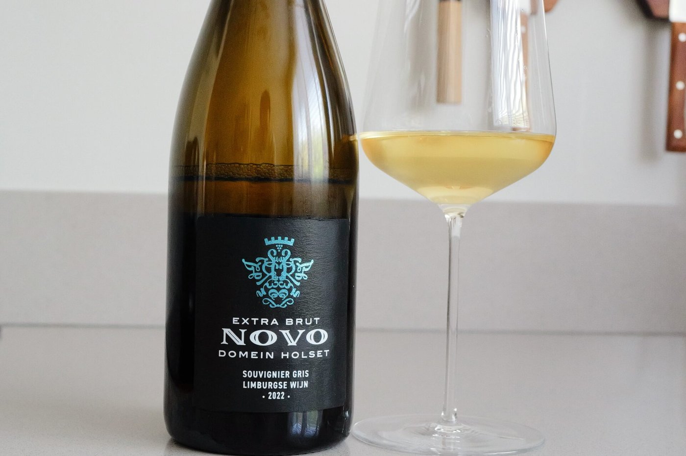 Bottle of Domein Holset Novo 2022 Dutch sparkling wine with glass