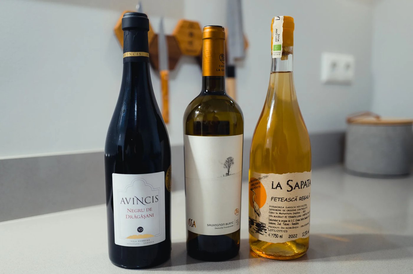 Multiple bottles of Romanian wines from MICU on a table