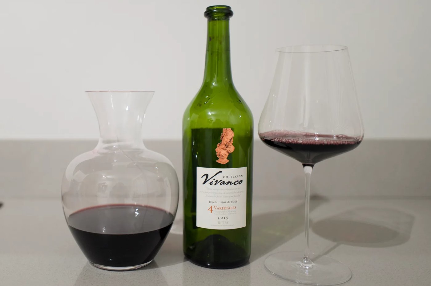Bottle of Colección Vivanco 4 Varietales 2019 Rioja beside a decanter and a glass of red wine