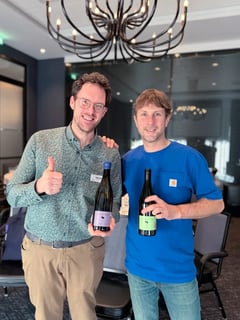 Jeroen Vonk and Damien Delecheneau together at the ViniBio 2026 hospitality lounge with two La Grange Tiphaine bottles