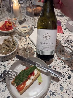 Italian wines from Fattoria Fibbiano and Tenuta Antica Cavalleria on the table at a wine dinner