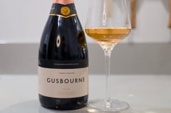 Gusbourne Rosé sparkling wine with salmon-pink bubbles in a glass