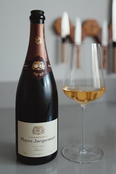 Two grower Champagne bottles from Henri Chauvet and Ployez-Jacquemart side by side, supplied by House Du Champagne.