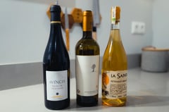 Multiple bottles of Romanian wines from MICU on a table