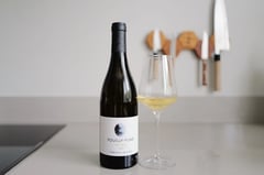 Bottle of Pouilly-Fumé MCMLV 2023 from Domaine du Bouchot beside a poured glass