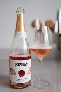 Bottle of Zeno Sparkling Rosé alcohol-free sparkling rosé beside a glass