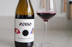 Bottle of Zeno Tempranillo Cabernet alcohol-free red wine beside a glass