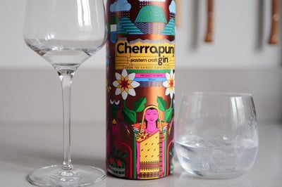 Cherrapunji Gin bottle from Meghalaya, India, against a rainforest backdrop