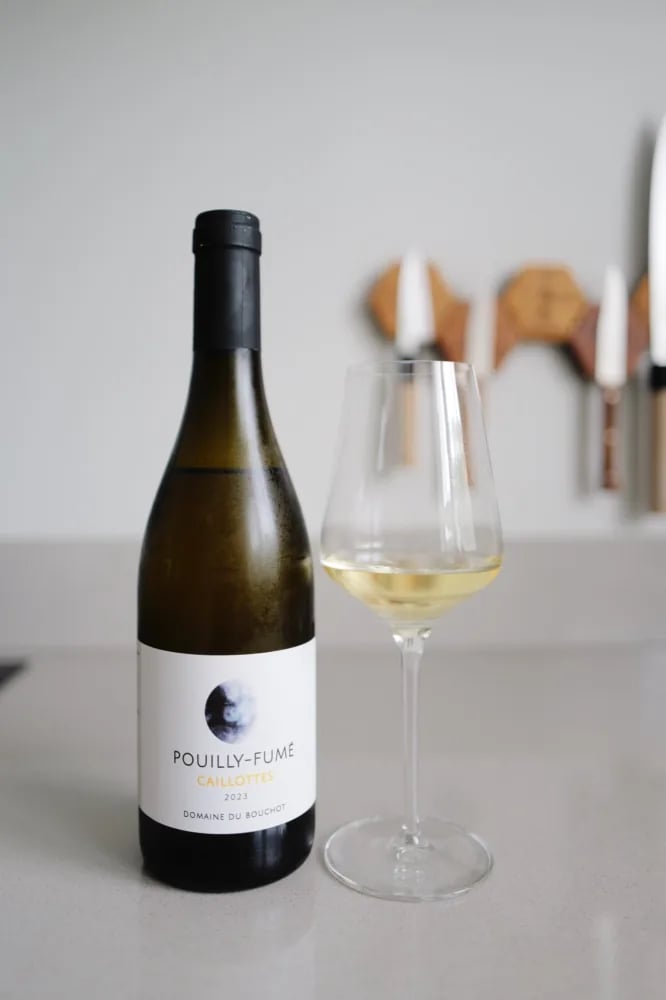 Bottle of Pouilly-Fumé Caillottes 2023 from Domaine du Bouchot beside a poured glass