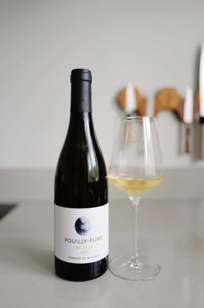 Bottle of Pouilly-Fumé MCMLV 2023 from Domaine du Bouchot beside a poured glass