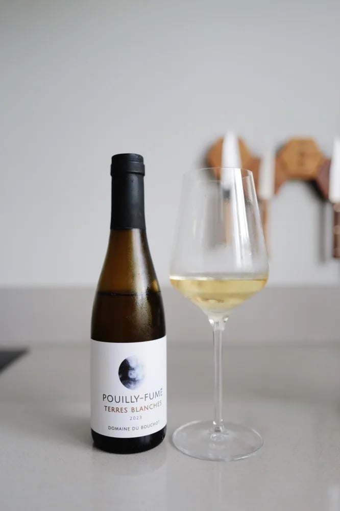 Bottle of Pouilly-Fumé Terres Blanches 2023 from Domaine du Bouchot beside a poured glass
